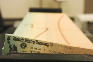 FILE - In this Feb. 11, 2005 file photo, trays of printed social security checks wait to be mailed from the U.S. Treasury's Financial Management services facility in Philadelphia. (AP Photo/Bradley C. Bower, File)