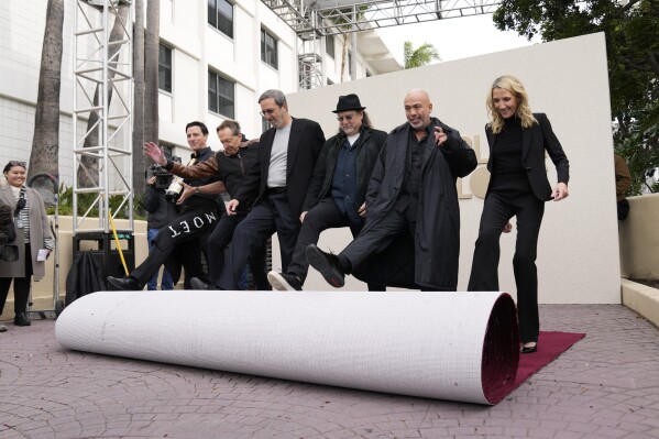 From left, Barry Adelman, Ricky Kirshner, Glenn Weiss, Jo Koy, and Helen Hoehne roll out the red carpet during the Golden Globe Awards Press Preview at the Beverly Hilton, Thursday, Jan. 4, 2024, in Beverly Hills, Calif. (AP Photo/Ashley Landis)