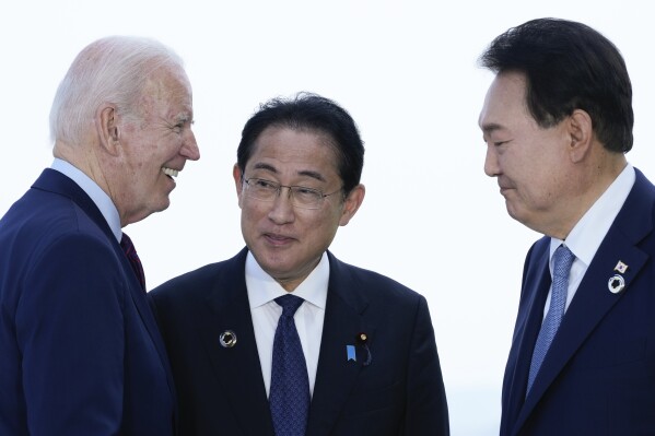 FILE - President Joe Biden, left, talks with Japan's Prime Minister Fumio Kishida and South Korean President Yoon Suk Yeol, right, ahead of a trilateral meeting on the sidelines of the G7 Summit in Hiroshima, Japan, Sunday, May 21, 2023. Biden aims to further tighten security and economic ties between Japan and South Korea, two nations that have struggled to stay on speaking terms, as he welcomes their leaders to the rustic Camp David presidential retreat Friday, Aug. 18. (AP Photo/Susan Walsh, File)
