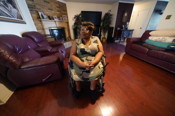 India Scott sits in the living room of her home in New Orleans, Monday, Oct. 10, 2022. Activists, advocates, researchers and people living with disabilities say not enough is being done to include disabled people in climate action planning and policy, or disaster relief and recovery efforts. (AP Photo/Gerald Herbert)