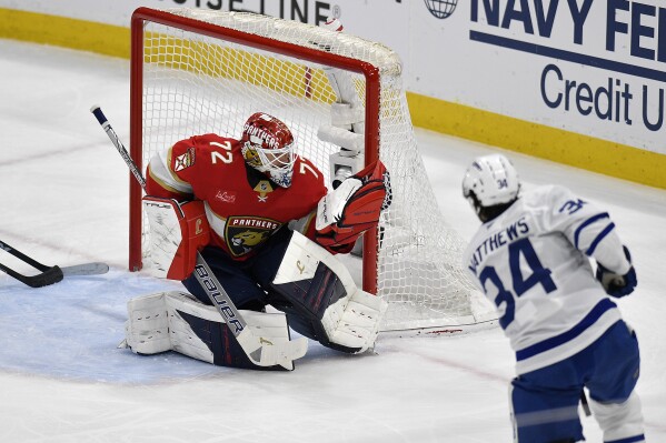 Florida Panthers goaltender Sergei Bobrovsky (72) catches the puck in front of Toronto Maple Leafs center Auston Matthews (34) during the first period of Game 4 of a second-round NHL hockey playoff series, Sunday, May 11, 2025, in Sunrise, Fla. (AP Photo/Michael Laughlin)