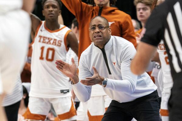 Texas acting head coach Rodney Terry urges his team on during the first half of an NCAA college basketball game against Stanford Sunday, Dec. 18, 2022, in Dallas. (AP Photo/Jeffrey McWhorter)