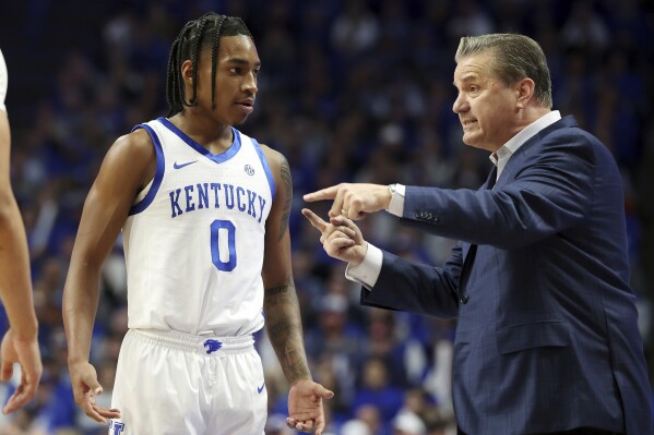 Kentucky's Rob Dillingham (0) receives instruction from head coach John Calipari during the second half of an NCAA college basketball game against Mississippi State, Wednesday, Jan. 17, 2024, in Lexington, Ky. Kentucky won 90-77. (AP Photo/James Crisp)