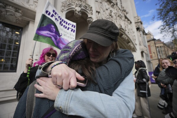 Women's rights activists celebrate outside the Supreme Court to challenge gender recognition laws, in London, Wednesday, April 16, 2025. (AP Photo/Kin Cheung)