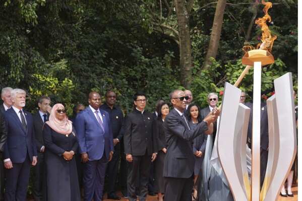 Rwandan President Paul Kagame lights a memorial flame during a ceremony to mark the 30th anniversary of the Rwandan genocide, held at the Kigali Genocide Memorial, in Kigali, Rwanda, Sunday, April 7, 2024. Rwandans are commemorating 30 years since the genocide in which an estimated 800,000 people were killed by government-backed extremists, shattering this small east African country that continues to grapple with the horrific legacy of the massacres. (AP Photo/Brian Inganga)