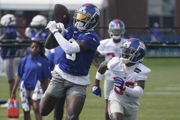 New York Giants' Parris Campbell, left, is covered by Darnay Holmes (30) during a drill at the NFL football team's training facility in East Rutherford, N.J., Thursday, July 27, 2023. (AP Photo/Seth Wenig)
