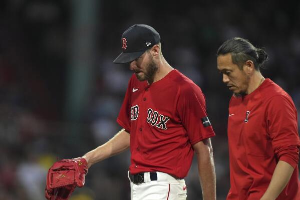 Boston Red Sox's Chris Sale, left, walks to the dugout after being removed during the fourth inning of the team's baseball game against the Cincinnati Reds, Thursday, June 1, 2023, in Boston. (AP Photo/Steven Senne)