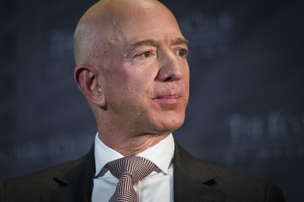 
              FILE- In this Sept. 13, 2018, file photo Jeff Bezos, Amazon founder and CEO, speaks at The Economic Club of Washington's Milestone Celebration in Washington. An attorney for the head of the National Enquirer’s parent company says the tabloid didn’t commit extortion or blackmail by threatening to publish Bezos’ explicit photos. Elkan Abramowitz represents American Media Inc. CEO David Pecker. He defended the tabloid’s practice as a “negotiation” in an interview Sunday, with ABC News.(AP Photo/Cliff Owen, File)
            