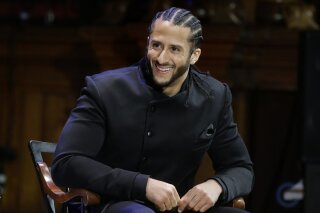 FILE - In this Oct. 11, 2018, file photo, former NFL football quarterback Colin Kaepernick smiles on stage during W.E.B. Du Bois Medal ceremonies at Harvard University, in Cambridge, Mass. Kaepernick plans to audition for NFL teams on Saturday, Nov. 16, 2019, in a private workout arranged by the league to be held in Atlanta. (AP Photo/Steven Senne, File)