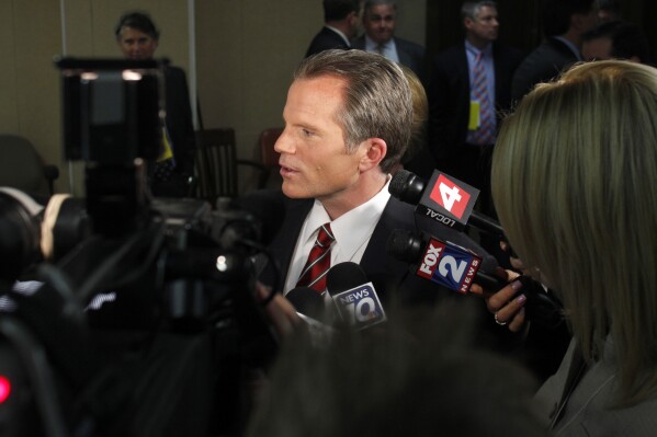 Republican gubernatorial candidate, Michigan Attorney General Mike Cox, talks to reporters following a debate, on April 21, 2010, in East Lansing, Mich. (AP Photo/Al Goldis, File)