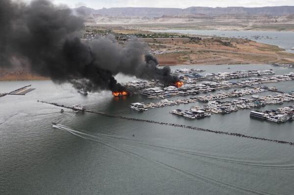 This photo provided by the National Park Service shows a houseboat fire in Wahweap Marina on Lake Powell, Friday, June 2, 2023, near Page, Ariz. Investigators have ruled a fire that damaged several houseboats on Lake Powell, a popular destination on the Utah-Arizona line, was an accident, the National Park Service announced Friday, June 9. (National Park Service via AP)