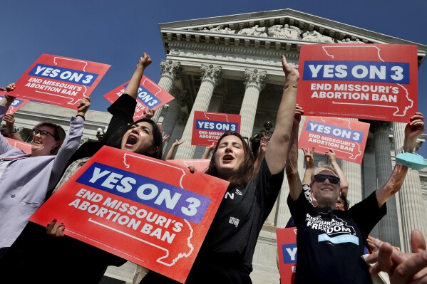 Amendment 3 supporters Luz Maria Henriquez, second from left, executive director of the ACLU Missouri, celebrates with Mallory Schwarz, center, of Abortion Action Missouri, after the Missouri Supreme Court in Jefferson City, Mo., ruled that the amendment to protect abortion rights would stay on the November ballot. (Robert Cohen/St. Louis Post-Dispatch via AP, File)