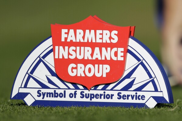 FILE - The logo for the Farmers Insurance Group is seen on the North Course during the first round of the Farmers Insurance Open golf tournament, Jan. 26, 2012, in San Diego. Farmers Insurance will lay off 11% of its workforce — or about 2,400 employees — as part of restructuring efforts, the company announced Monday, Aug. 28, 2023. (AP Photo/Gregory Bull, File)
