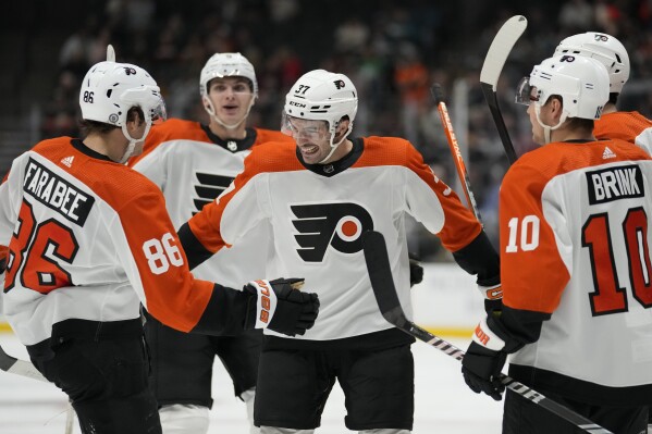Philadelphia Flyers defender Louie Belpedio (37) celebrates with left wing Joel Farabee (86) after scoring during the second period of an NHL hockey game against the Anaheim Ducks in Anaheim, Calif., Friday, Nov. 10, 2023. (AP Photo/Ashley Landis)