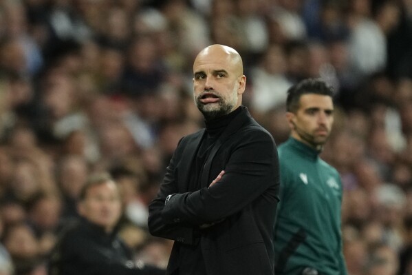 Manchester City's head coach Pep Guardiola gestures during the Champions League quarterfinal first leg soccer match between Real Madrid and Manchester City at the Santiago Bernabeu stadium in Madrid, Spain, Tuesday, April 9, 2024. (AP Photo/Jose Breton)