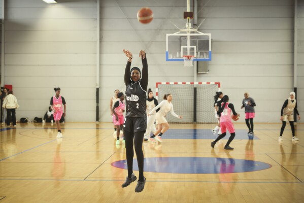 A player wearing a headscarf warmup before a competition, in Aubervilliers near Paris, Sunday, April 27, 2025. (AP Photo/Thomas Padilla)