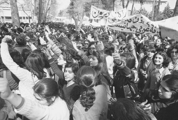 File - Iranian women demonstrate for equal rights, March 12, 1979. Iran's Islamic Republic requires women to cover up in public. But many Iranian women have long played a game of cat-and-mouse with authorities as a younger generation wears their veils more loosely or skirts requirements for conservative dress. (AP Photo/Richard Tomkins, File)