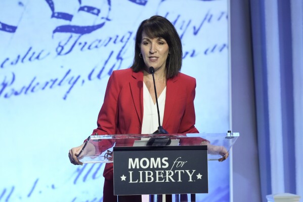 FILE - Moms for Liberty co-founder Tina Descovich speaks at the Moms for Liberty meeting in Philadelphia, June 30, 2023. The conservative parental rights group Moms for Liberty plans to spend more than $3 million on a multi-state advertising blitz to increase its membership and engage voters before November. (AP Photo/Matt Rourke)