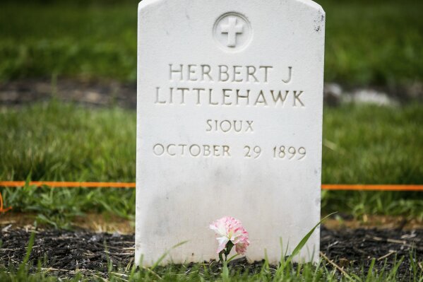 
              FILE - This photo taken June 13, 2018, shows a gravesite of Herbert Littlehawk at the cemetery at the Carlisle Indian School in Carlisle, Pa. Littlehawk, an American Indian student who was taken from his family, is buried at the site. The forced separation of Latino migrant children from their parents has generated strong condemnation of President Trump's immigration policies but it's not the first time the U.S. government or authorities have been involved in separating children from their families. (Sean Simmers/The Patriot-News via AP)
            