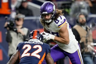 Minnesota Vikings tight end T.J. Hockenson (87) runs after the catch as Denver Broncos safety Kareem Jackson (22) defends during the first half on an NFL football game, Sunday, Nov. 19, 2023, in Denver. (AP Photo/Jack Dempsey)