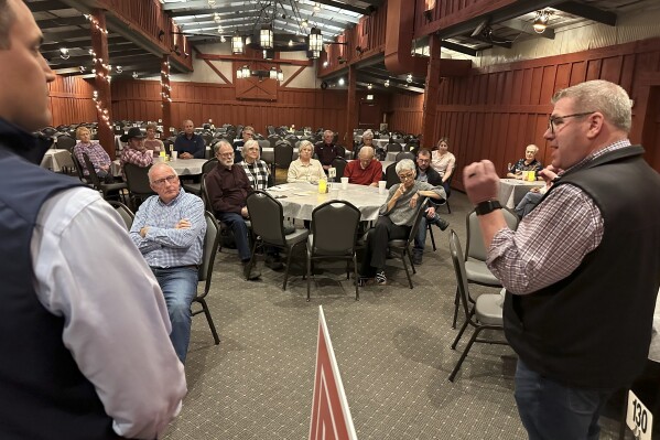 Congressional candidate Darren Bailey, right, speaks to a crowd at a restaurant during a campaign stop with state Rep. Adam Niemerg, Tuesday, Feb. 27, 2024, in Casey, Ill. Bailey, a former state senator and 2022 Republican nominee for governor, is running in the March 19th primary to unseat fellow GOP Congressman Mike Bost, a five-term incumbent who has the endorsement of former President Donald Trump, in Illinois' 12th District, which encompasses the bottom one-third of Illinois. (AP Photo/John O'Connor)