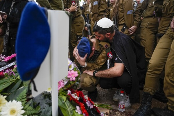 The family of Israeli soldier Cpl. Avraham Fetena mourn during his funeral in Haifa, Israel, Friday, Nov. 17, 2023. (AP Photo/Ariel Schalit)