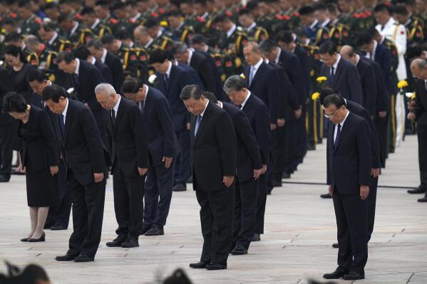 Chinese President Xi Jinping, center, leads other members of the Chinese Politburo Standing Committee including Premier Li Keqiang, right, to bow as they pay respects before the Monument to the People's Heroes during a ceremony to mark Martyr's Day at Tiananmen Square in Beijing, Thursday, Sept. 30, 2021. (AP Photo/Andy Wong)