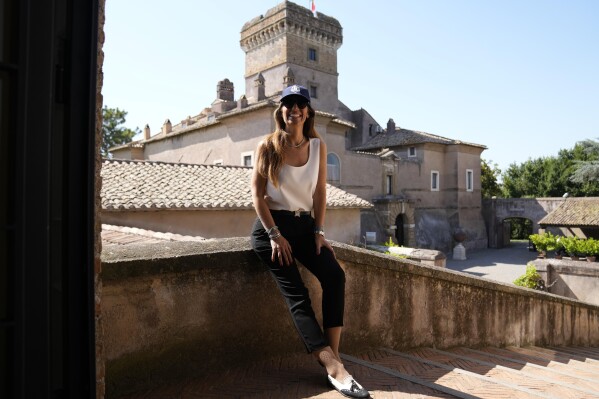 Fashion designer and owner of the Marco Simone Golf Club Lavinia Biagiotti Cigna poses for a photo during an interview with the Associated Press, in her castle next to the course that will host the 44th edition of the Ryder Cup, in Guidonia Montecelio, Italy, Tuesday, July 11, 2023. Biagiotti Cigna’s parents bought the 11th-century castle in 1978 and then decided to build the surrounding golf course. The castle contains about 50 rooms, many of which feature Renaissance-era frescoes. (AP Photo/Alessandra Tarantino)