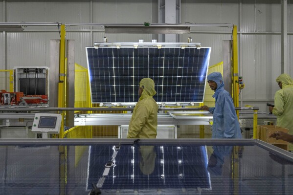 Employees work at the Adani New Industries Limited, one of India's largest solar panels and wafers manufacturing facility in the port town of Mundra in Western India's Gujarat state, India, Wednesday, Sept. 20, 2023. The world's renewable energy grew at its fastest rate in the past 25 years in 2023, the International Energy Agency reported Thursday, Jan. 11, 2024. (AP Photo/Rafiq Maqbool)