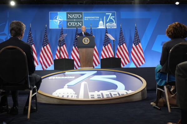 President Joe Biden speaks as Secretary of State Antony Blinken, seated at left, and White House press secretary Karine Jean-Pierre, seated at right, listen at a news conference following the NATO Summit in Washington, Thursday, July 11, 2024. (AP Photo/Susan Walsh)