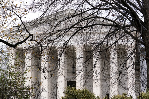 The Supreme Court is seen amid bare tree branches, on Capitol Hill in Washington, Dec. 7, 2023. (AP Photo/J. Scott Applewhite)