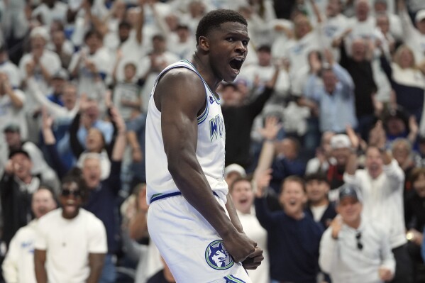 Minnesota Timberwolves guard Anthony Edwards celebrates after a dunk during the second half of Game 1 of an NBA basketball first-round playoff series against the Phoenix Suns, Saturday, April 20, 2024, in Minneapolis. (AP Photo/Abbie Parr)