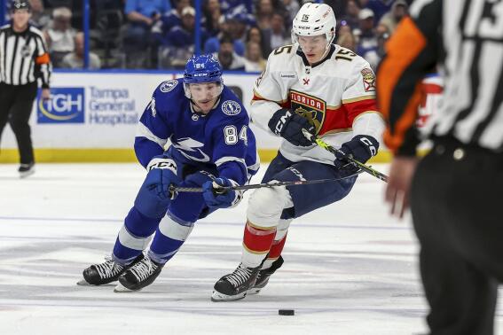 Tampa Bay Lightning's Tanner Jeannot and Florida Panthers' Anton Lundell compete for the puck during the second period of an NHL hockey game Tuesday, Feb. 28, 2023, in Tampa, Fla. (AP Photo/Mike Carlson)