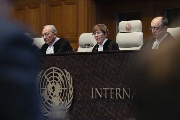 Presiding judge Joan Donoghue, center, reads the International Court of Justice's, the United Nations top court, ruling in The Hague, Netherlands, Friday, Feb. 2, 2024, on whether it has jurisdiction to hear a case filed by Ukraine in the days after Russia's invasion accusing Moscow of breaching the genocide convention. In the highly-charged case, Kyiv claims that Russia breached the landmark 1948 convention by using trumped-up claims of genocide in the eastern regions of Luhansk and Donetsk as a pretext for attacking Ukraine nearly two years ago. (AP Photo/Peter Dejong)