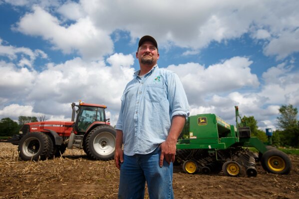 
              CORRECTS YEAR TO 2018 - In this May 22, 2018, photo, farmer Tim Bardole pauses for a photo as he plants a field near Perry, Iowa. Donald Trump won the presidency by winning rural America, in part by pledging to use his business savvy and tough negotiating skills to take on China and put an end to trade practices that have hurt farmers for years. While the prolonged fight has been devastating to an already-struggling agriculture industry, there’s little indication Trump is paying a political price. (Zach Boyden-Holmes/The Des Moines Register via AP)
            