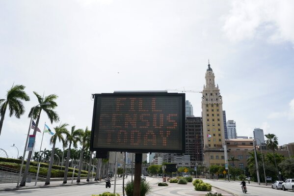 FILE - In this Oct. 5, 2020, file photo, a flashing sign near the iconic "Freedom Tower," advises people to fill out their census forms in downtown Miami. The Supreme Court’s decision to allow the Trump administration to end the 2020 census was another case of whiplash for the census, which has faced stops from the pandemic, natural disasters and court rulings. (AP Photo/Wilfredo Lee)