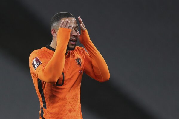 Netherlands' Memphis Depay reacts after a missed scoring opportunity during the World Cup 2022 group G qualifying soccer match between Turkey and Netherlands at the Ataturk Olimpiyat Stadium in Istanbul, Turkey, Wednesday, March 24, 2021. (Tolga Bozoglu/Pool Photo via AP)