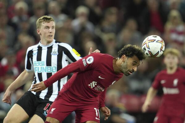 Liverpool's Mohamed Salah, heads the ball while being pursued by Newcastle's Matt Targett during the English Premier League soccer match between Liverpool and Newcastle United at Anfield stadium in Liverpool, England, England, Wednesday, Aug. 31, 2022. (AP Photo/Jon Super)