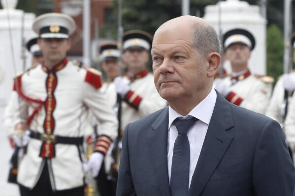 German Chancellor Olaf Scholz walks past the honor guard accompanied by North Macedonia's Prime Minister Dimitar Kovacevski, during a welcome ceremony at the government building in Skopje, North Macedonia, on Saturday, June 11, 2022. German Chancellor Olaf Scholz arrived Saturday in Skopje, as a part of his Balkan's tour in a bid to unblock the North Macedonia's strive to start the EU membership talks, burdened by Bulgarian veto. (AP Photo/Boris Grdanoski)