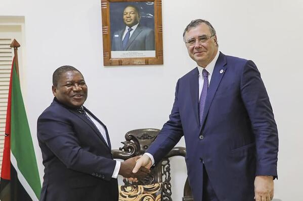 In this photo supplied by the Mozambican Presidency, Mozambican President Filipe Nyusi, left, shakes hands with TotalEnergies CEO Patrick Pouyanne at a meeting in Maputo, Mozambique, Friday, Feb. 3 2023. Extremist rebels in the county's northern Cabo Delgado province have killed a worker for an international charity shortly after a former vice president of the organization was asked to produce a report into the humanitarian situation in the conflict-hit region. In March 2021 Mozambique’s Islamic extremist insurgency forced the France-based firm TotalEnergies to put on hold its $20 billion liquified natural gas project in the north of the province. (Photo Mozambican Presidency via AP).