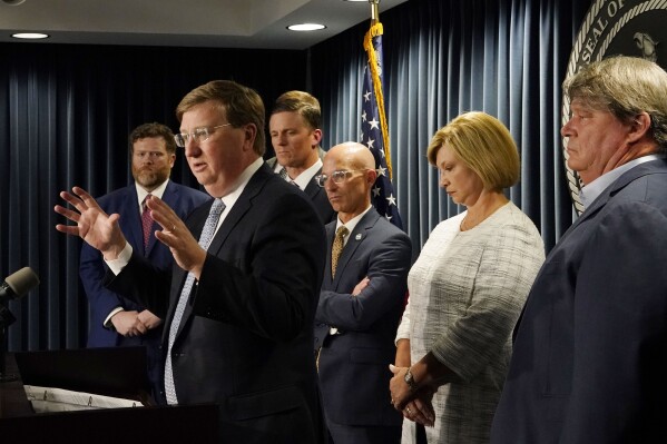 FILE - Mississippi Gov. Tate Reeves, second from left, announces a proposal that he says should alleviate financial problems for hospitals during a news conference Thursday, Sept. 21, 2023, in Jackson, Miss. The federal government has approved the first part of Mississippi’s plan to help some of the state’s financially struggling hospitals receive more Medicaid money, Reeves said Wednesday, Dec. 13.(AP Photo/Rogelio V. Solis)