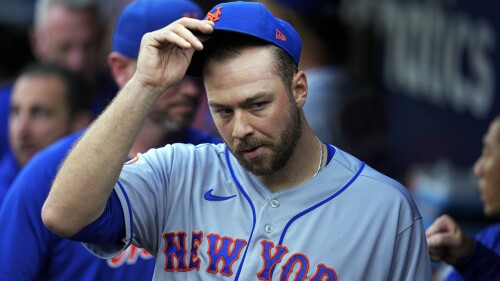 New York Mets starting pitcher Tylor Megill takes off his cap in the dugout before a baseball game against the Pittsburgh Pirates in Pittsburgh, Friday, June 9, 2023. (AP Photo/Gene J. Puskar)