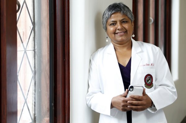 Dr. Manisha H. Shah stands outside her office at the Ohio State University Wednesday, Aug. 14, 2019, in Columbus, Ohio. Regardless of her reputation as a performer, Aretha Franklin's cancer doctors say she was no diva as a patient.  Shah and Dr. Philip Philip  say she didn't demand star treatment and was keen on doing whatever needed to be done. She also wanted to keep her music going as long as possible, which also impressed them.(AP Photo/Jay LaPrete)