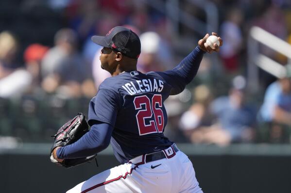 Atlanta Braves relief pitcher Raisel Iglesias, right, reacts with first  baseman Matt Olson, center, and third baseman Austin Riley (27) following  their victory over the Milwaukee Brewers in a baseball game Sunday