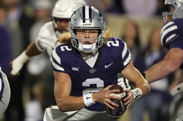 Kansas State quarterback Avery Johnson runs the ball during the first half of an NCAA college football game against Arizona State Saturday, Nov. 16, 2024, in Manhattan, Kan. (AP Photo/Charlie Riedel)