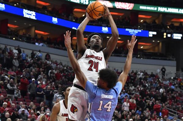 Louisville forward Jae'Lyn Withers (24) shoots over North Carolina guard Donovan Johnson (14) during the second half of an NCAA college basketball game in Louisville, Ky., Tuesday, Feb. 1, 2022. North Carolina won 90-83. (AP Photo/Timothy D. Easley)