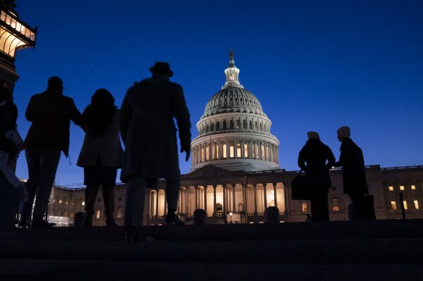 FILE - In this Jan. 22, 2020 file photo, night falls on the Capitol, in Washington. For many Americans, how they feel about issues raised during President Donald Trump's impeachment has much to do with where they get their news. That's among the findings of a study out Friday, Jan. 24,  by the Pew Research Center.   (AP Photo/J. Scott Applewhite, File)