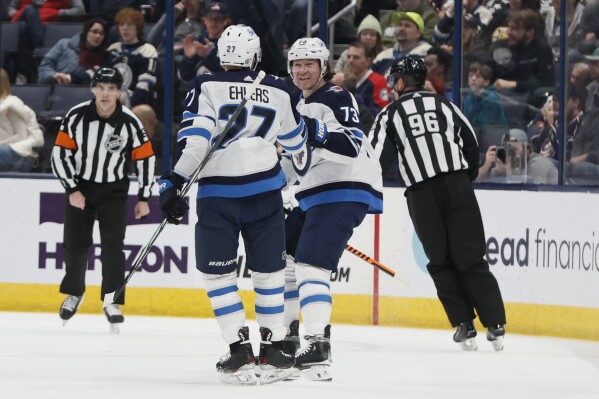 Winnepeg Jets' Tyler Toffoli (73) celebrates his goal against the Columbus Blue Jackets with teammate Nikolaj Ehlers (27) during the second period of an NHL hockey game Sunday, March 17, 2024, in Columbus, Ohio. (AP Photo/Jay LaPrete)