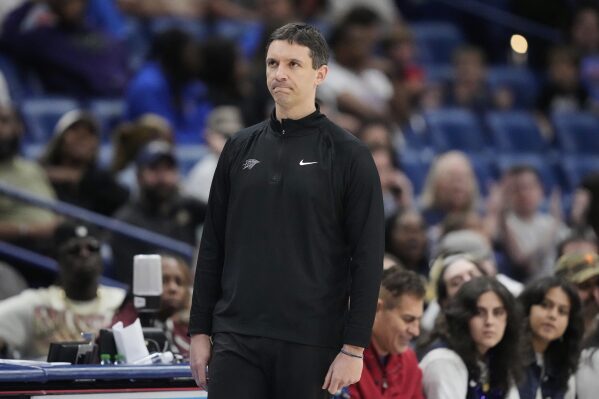 New Orleans Pelicans head coach Mark Daigneault watches from the bench in the second half of an NBA basketball game against the New Orleans Pelicans in New Orleans, Sunday, April 13, 2025. (AP Photo/Gerald Herbert)