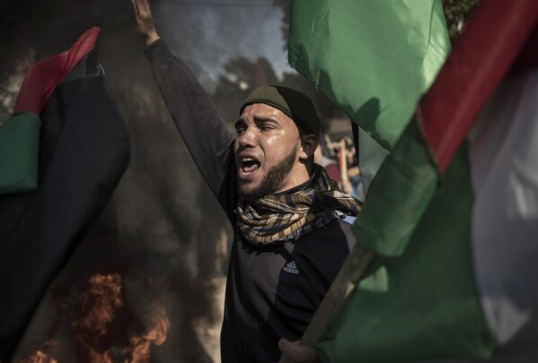Palestinian protesters chant angry slogans during a protest against the U.S. Mideast peace plan, in Gaza City, Monday, Jan. 28, 2020. U.S. President Donald Trump is set to unveil his administration's much-anticipated Mideast peace plan in the latest U.S. venture to resolve the Israeli-Palestinian conflict. (AP Photo/Khalil Hamra)